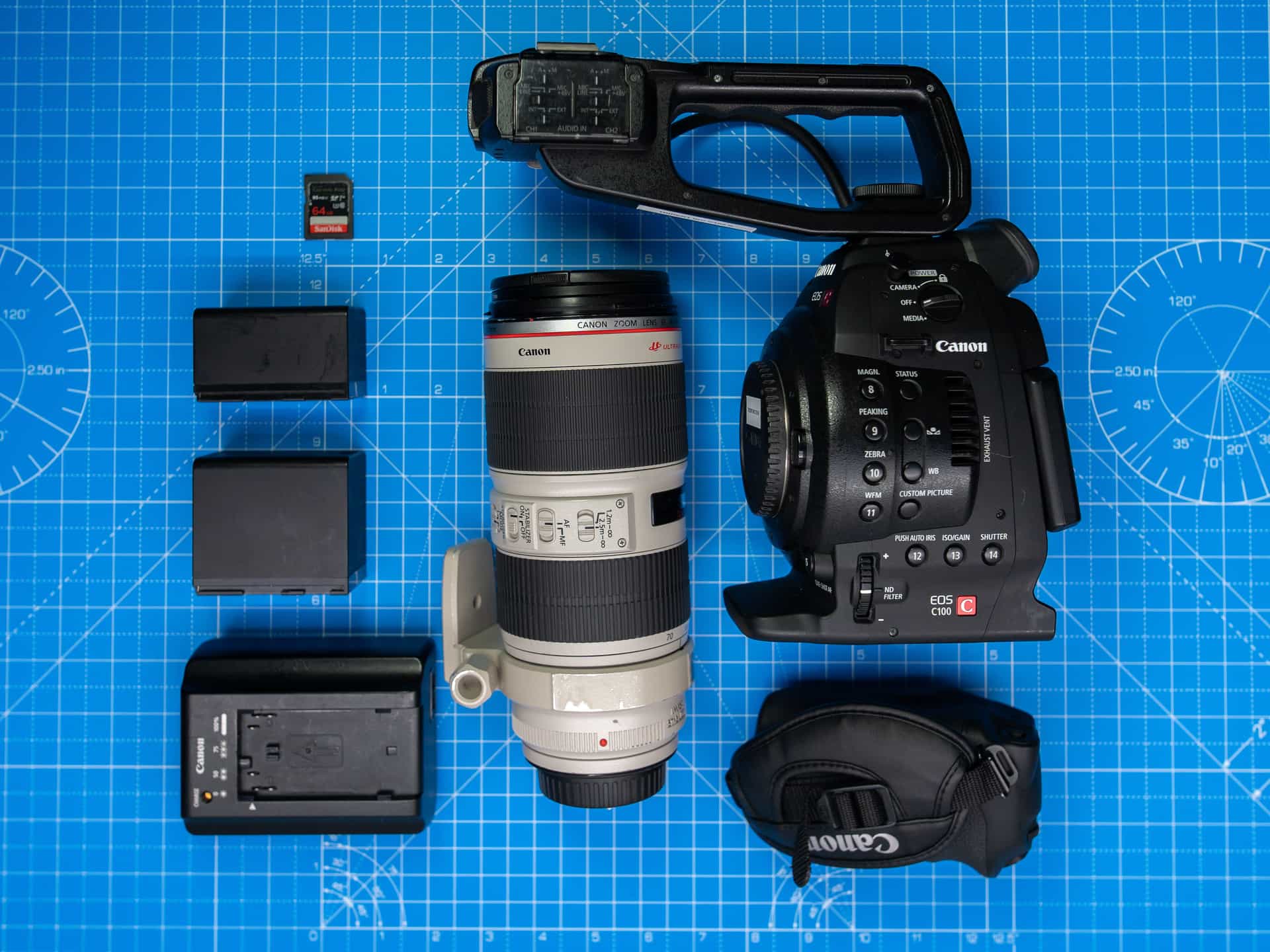 A flat lay of camera equipment, lenses and accessories