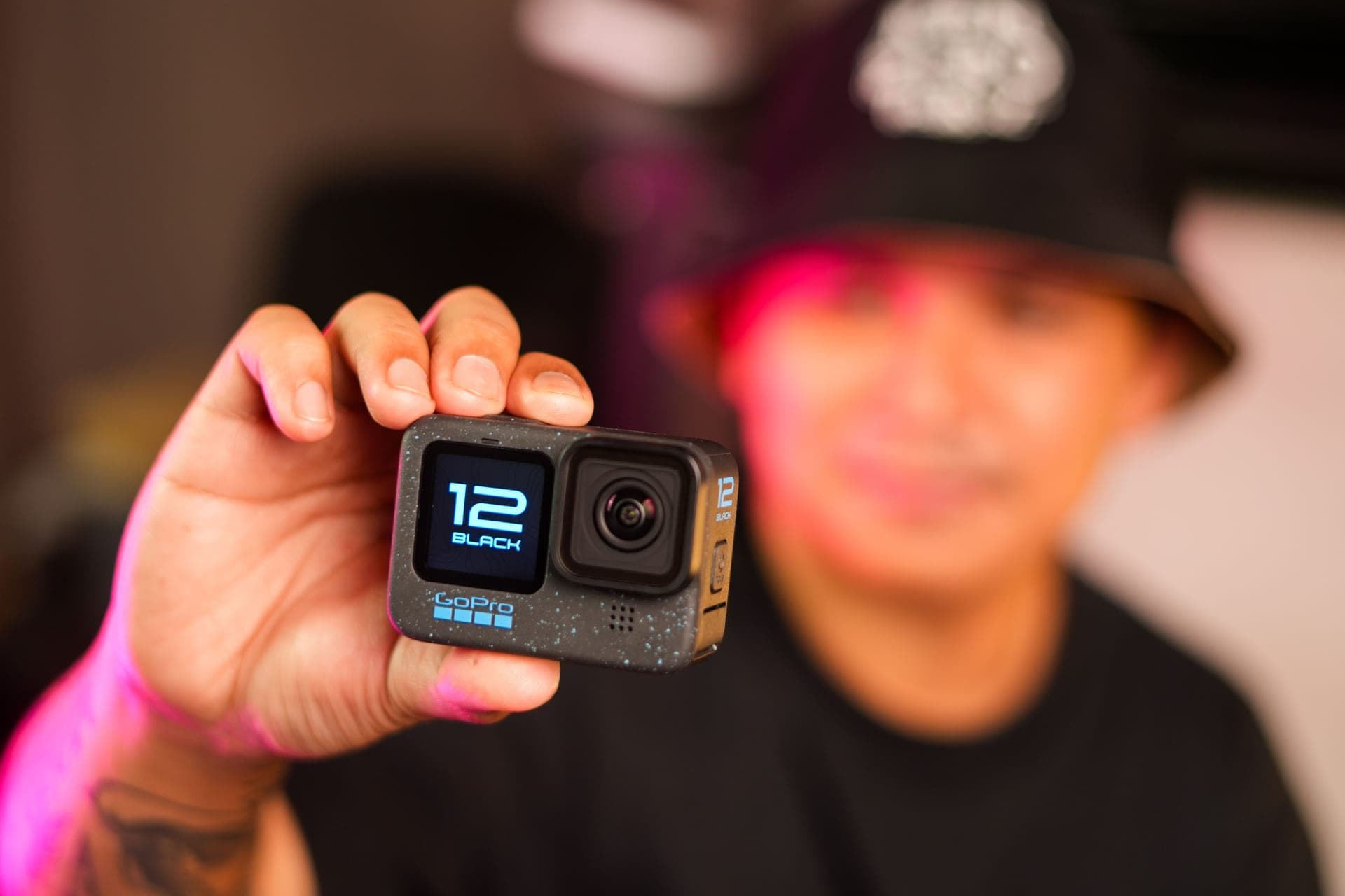 A close-up of a hand holding a small action camera