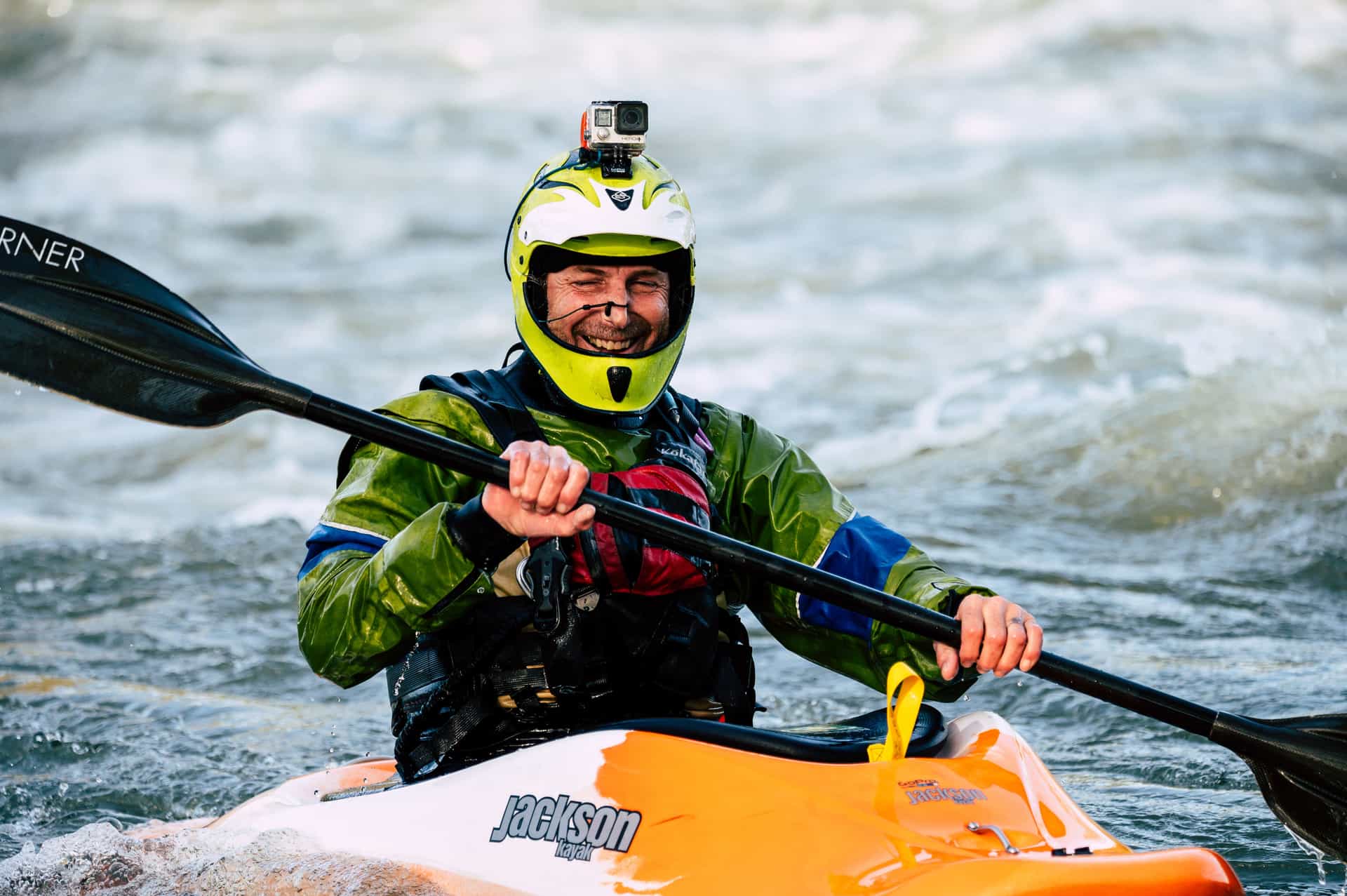 An action camera mounted on the deck of a kayak