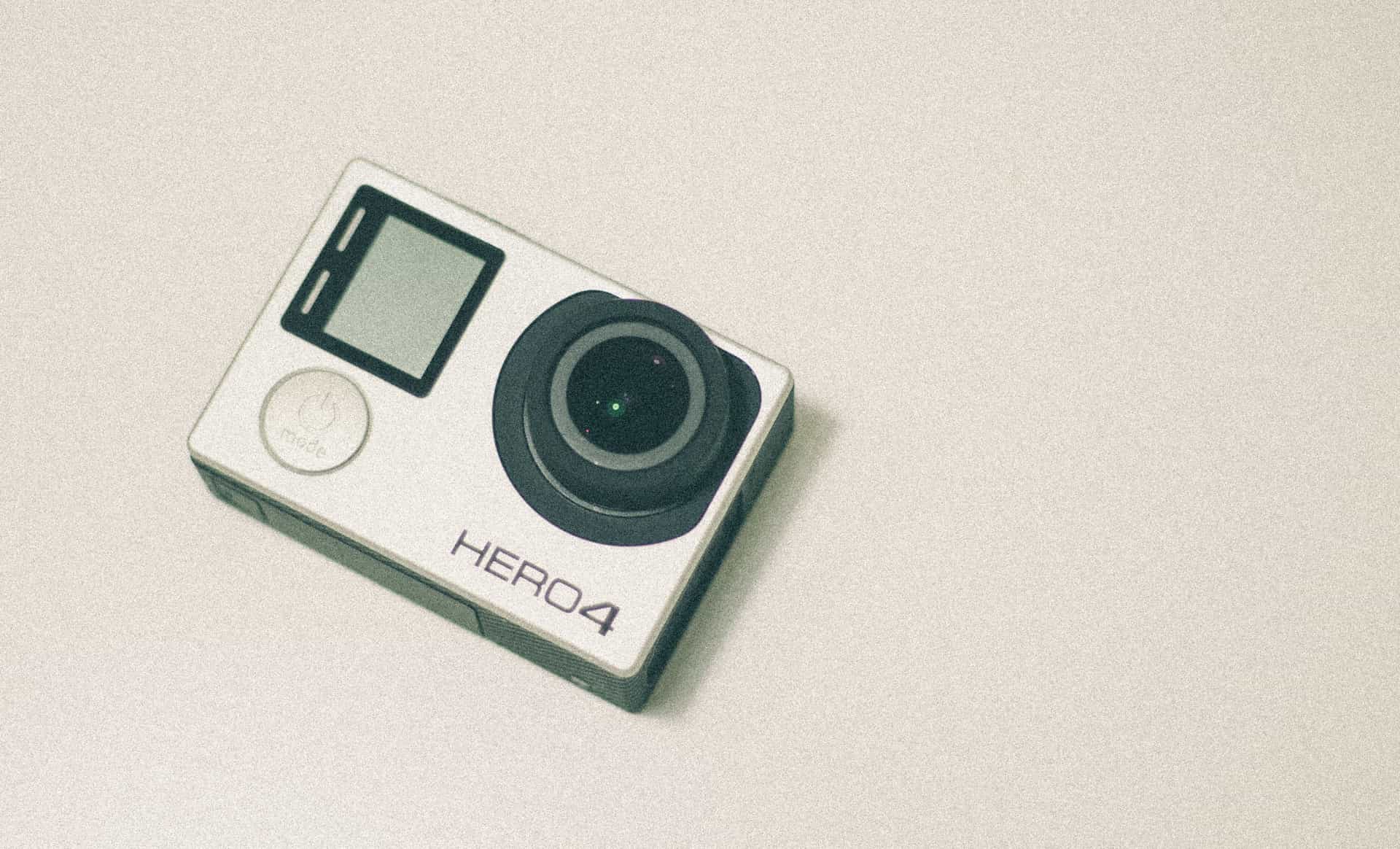 A compact action camera photographed from above on a plain background