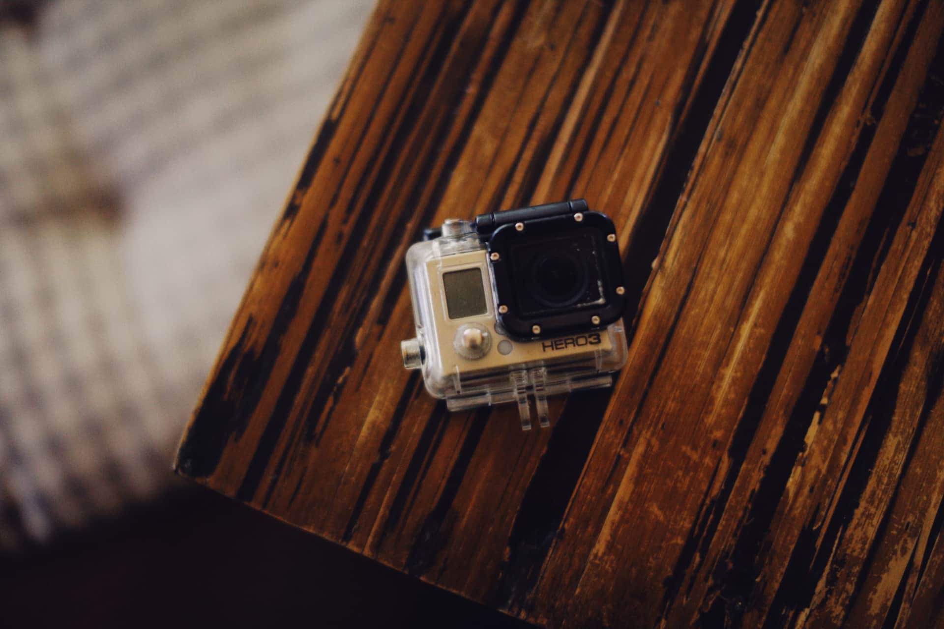 A compact action camera on a wooden table