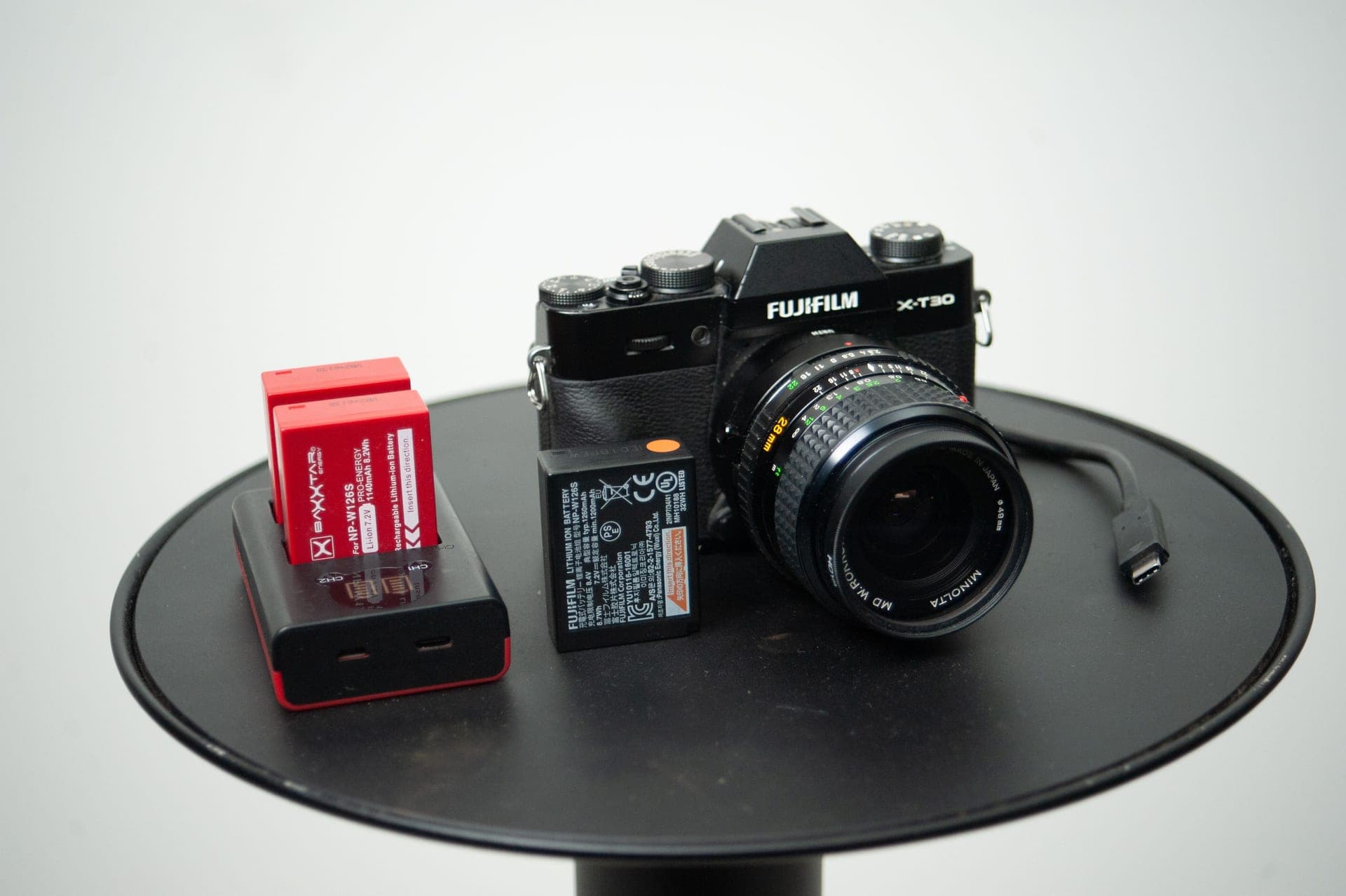 A camera with its battery and charger on a table