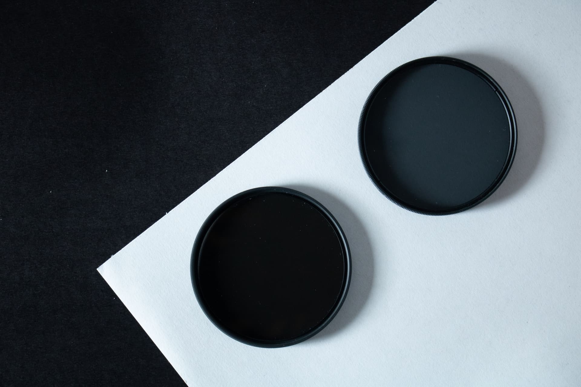 Two circular lens filters on a plain background