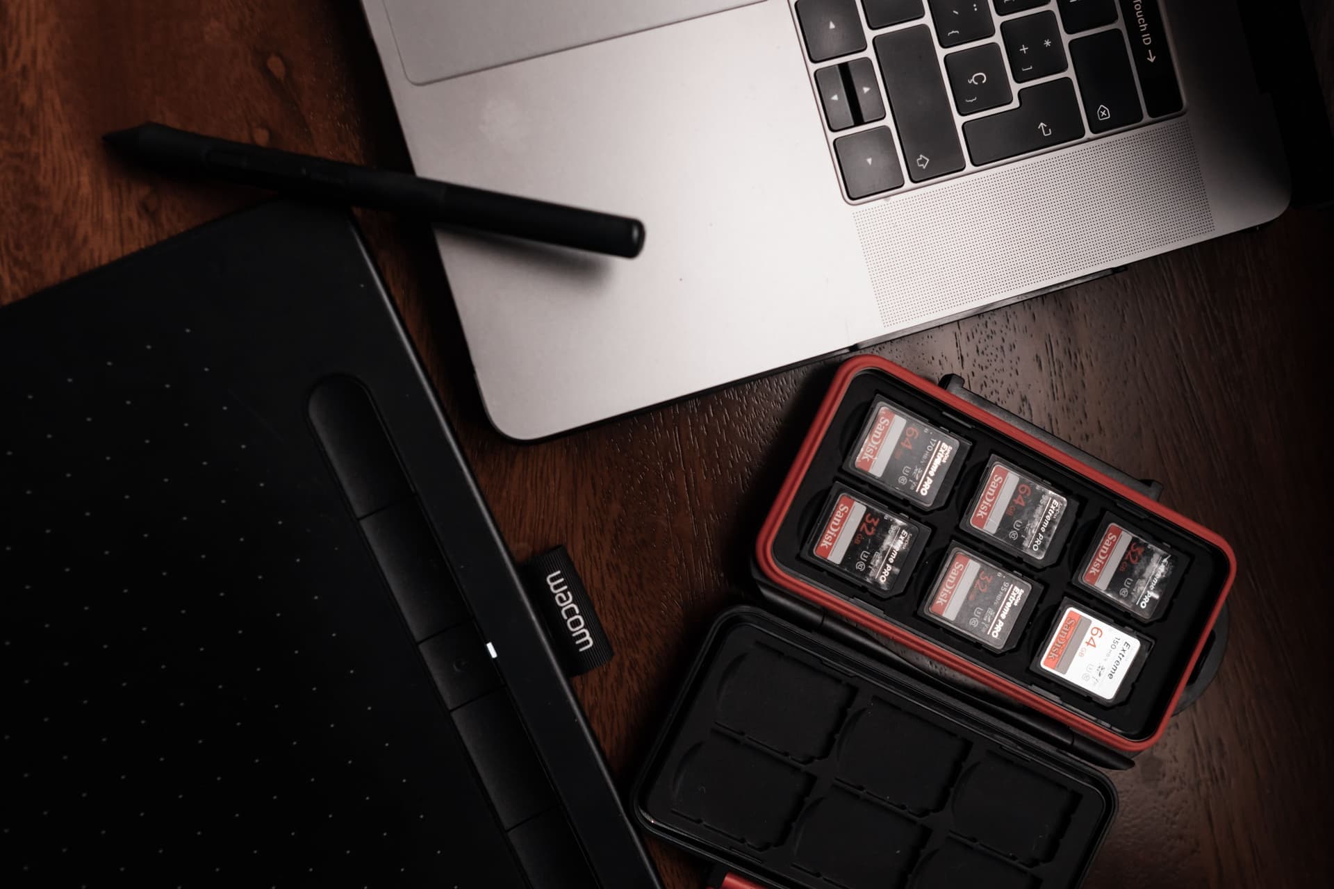 Memory cards on a desk beside a laptop