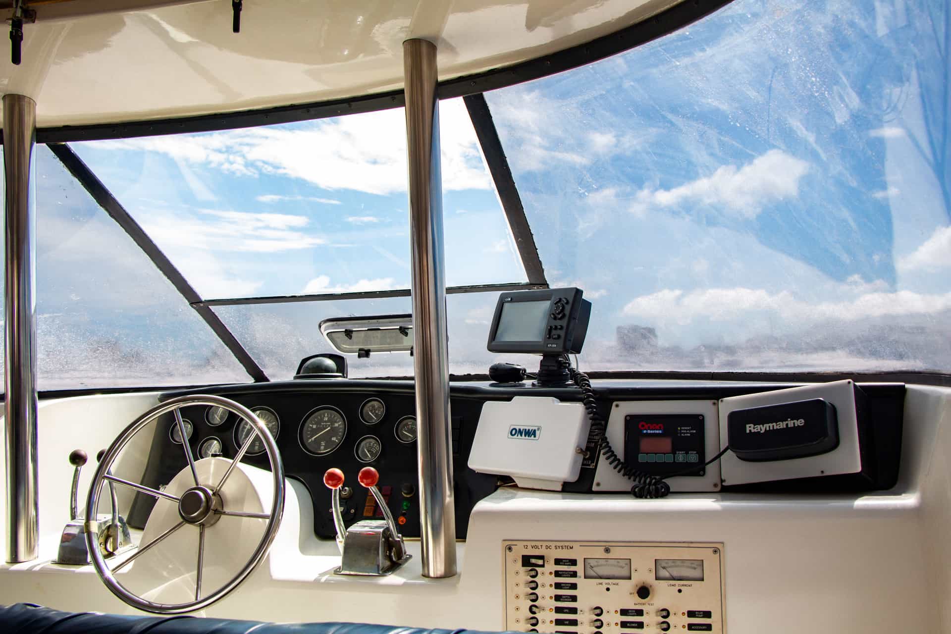 The cockpit of a boat, with the wheel and navigation instruments